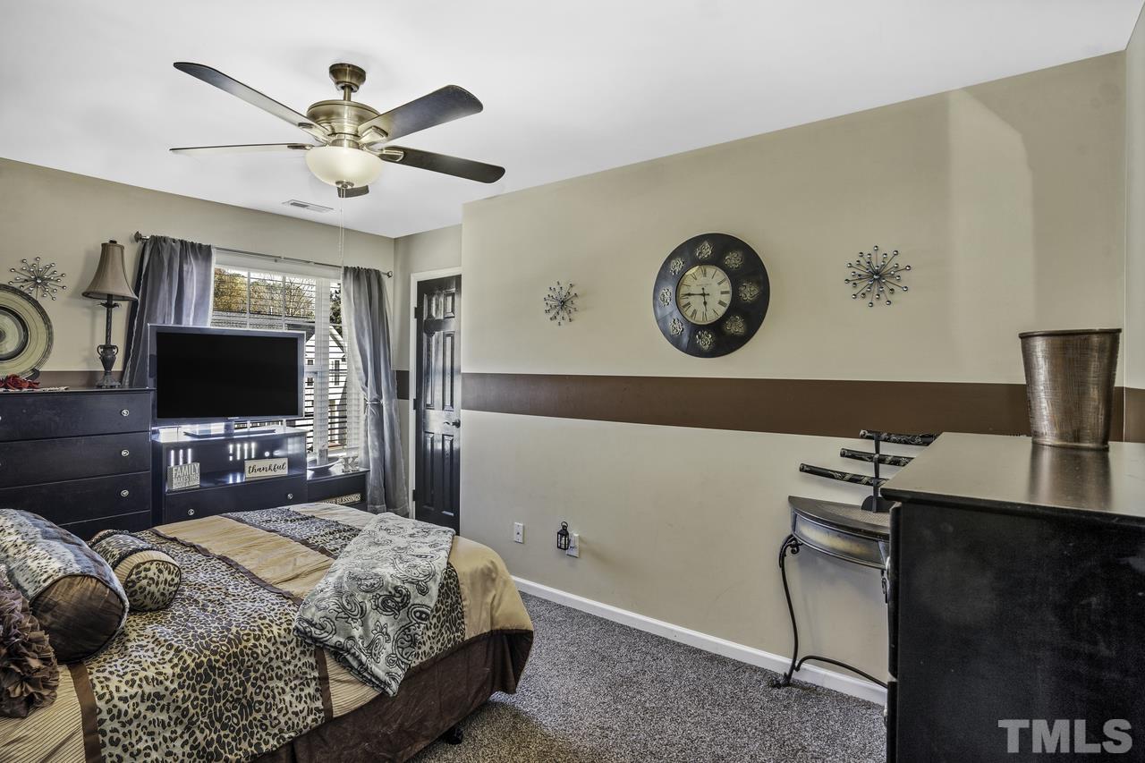 4704 Jelynn Street Raleigh, NC 27616 - Photo 19 of 30 a bedroom with a bed and a flat screen tv