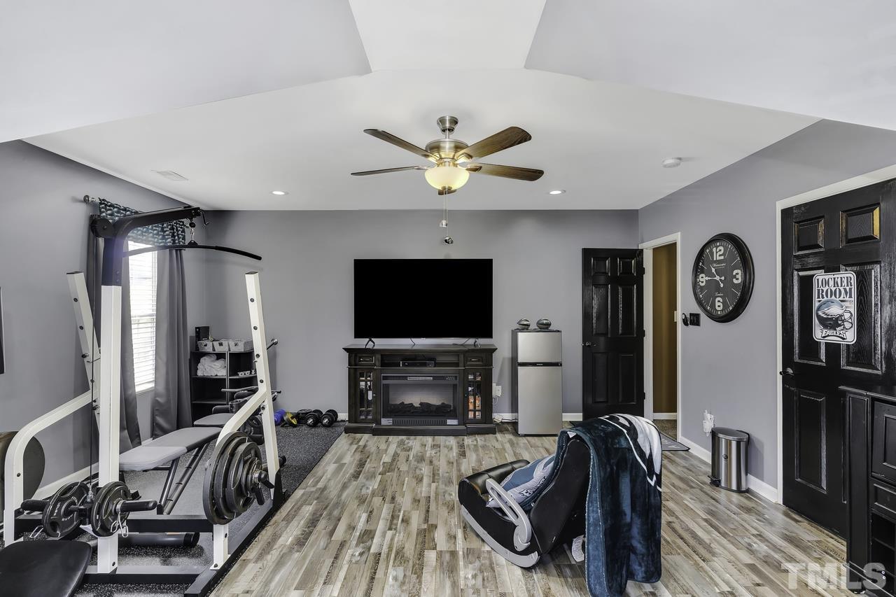 4704 Jelynn Street Raleigh, NC 27616 - Photo 24 of 30 a living room with furniture a flat screen tv and a fireplace