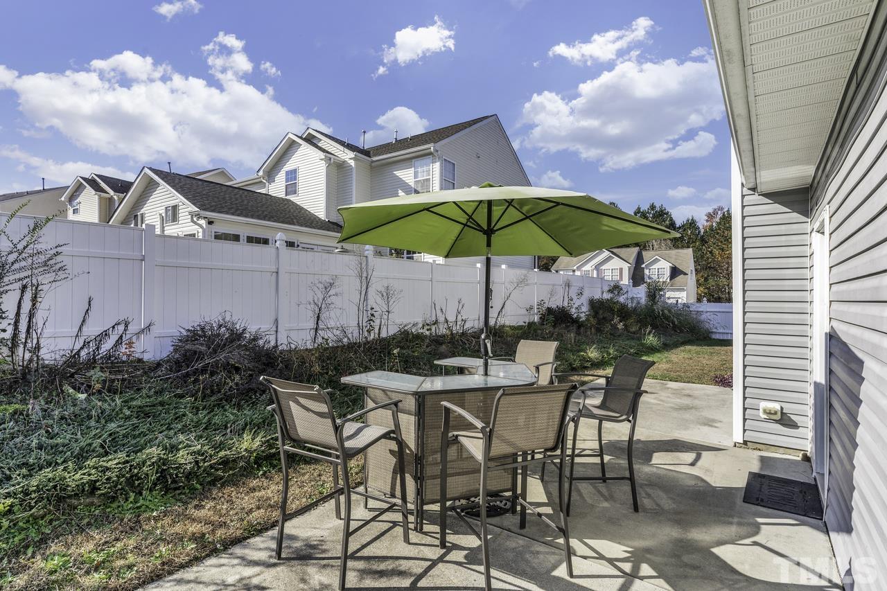 4704 Jelynn Street Raleigh, NC 27616 - Photo 28 of 30 a patio with a patio table and chairs