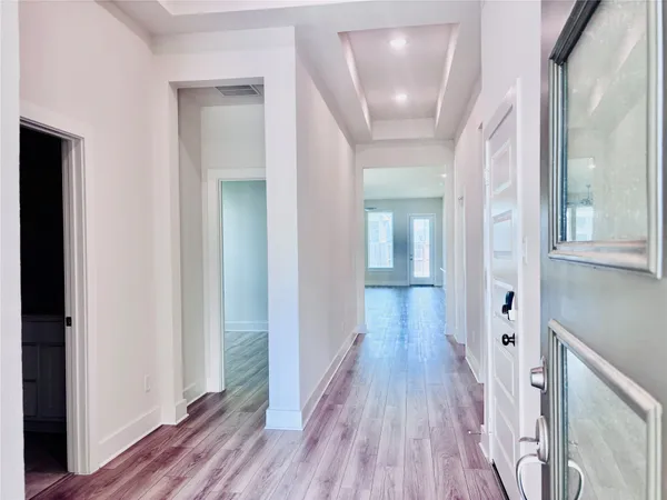 a view of hallway with wooden floor