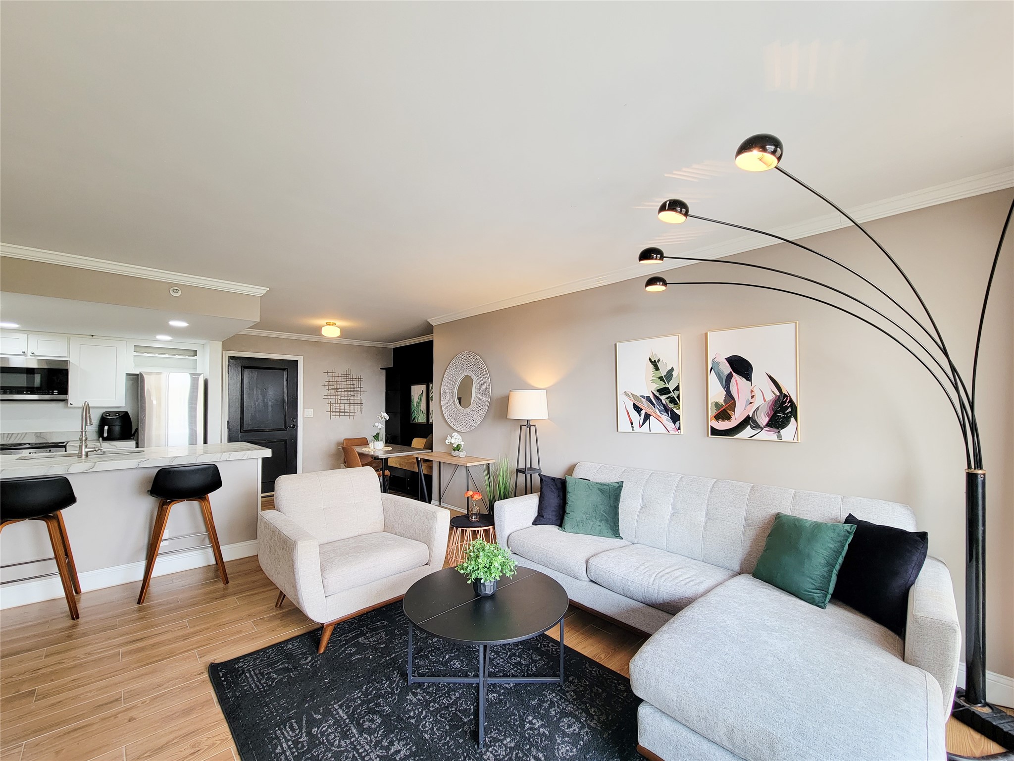 a living room with furniture and view of kitchen