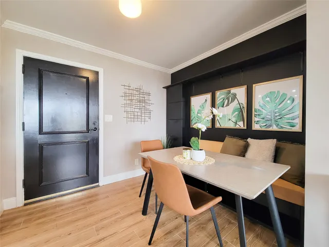 a kitchen with stainless steel appliances kitchen island granite countertop wooden floor a refrigerator and a sink