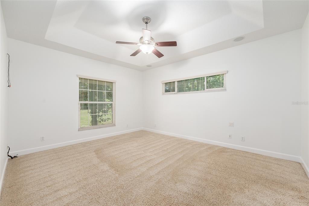 4735 Southeast 112th Street Road Belleview, FL 34420 - Photo 31 of 73 an empty room with windows and fan