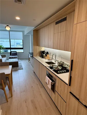 a kitchen with sink cabinets and wooden floor