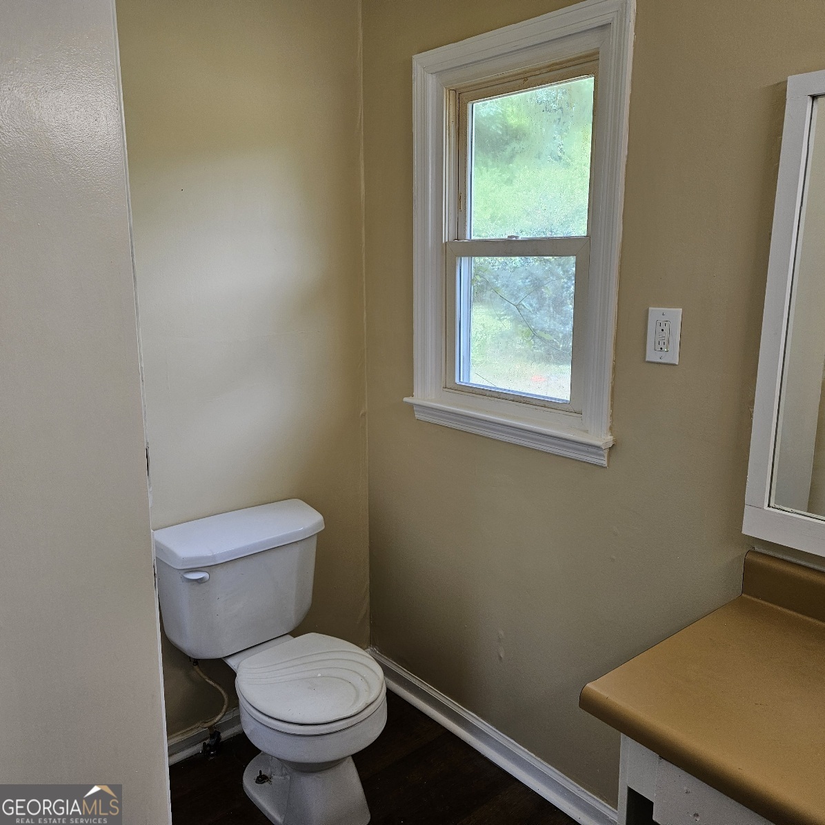 7067 Moseley Road Fort Valley, GA 31030 - Photo 14 of 37 a white toilet sitting next to a window in a bathroom