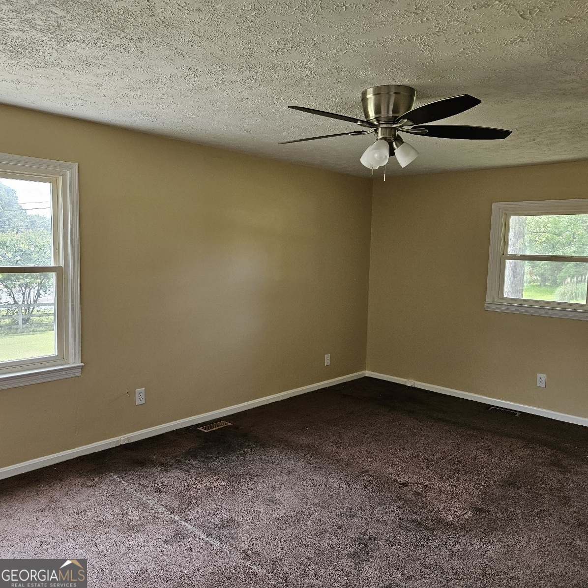 7067 Moseley Road Fort Valley, GA 31030 - Photo 16 of 37 an empty room with a window and a fan