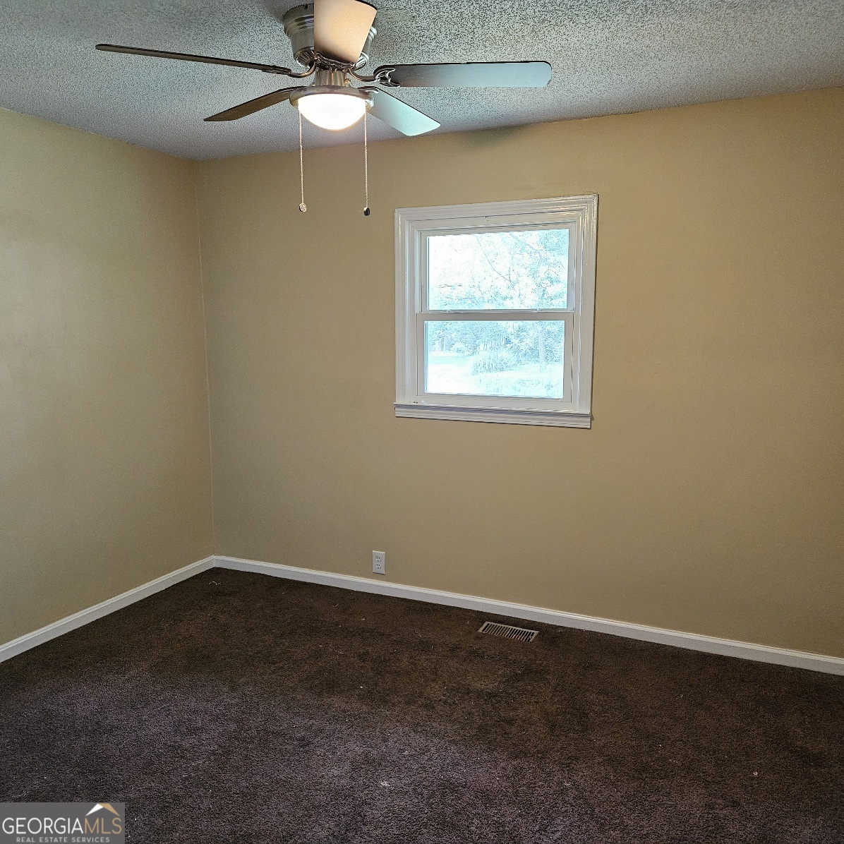 7067 Moseley Road Fort Valley, GA 31030 - Photo 22 of 37 an empty room with a window and a fan
