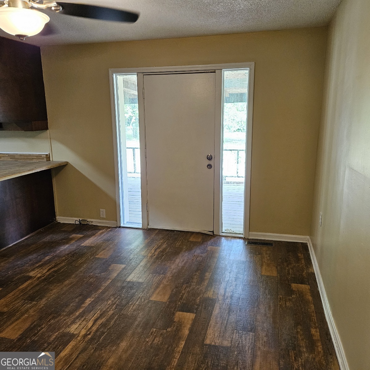 7067 Moseley Road Fort Valley, GA 31030 - Photo 26 of 37 a view of an empty room with wooden floor and a window