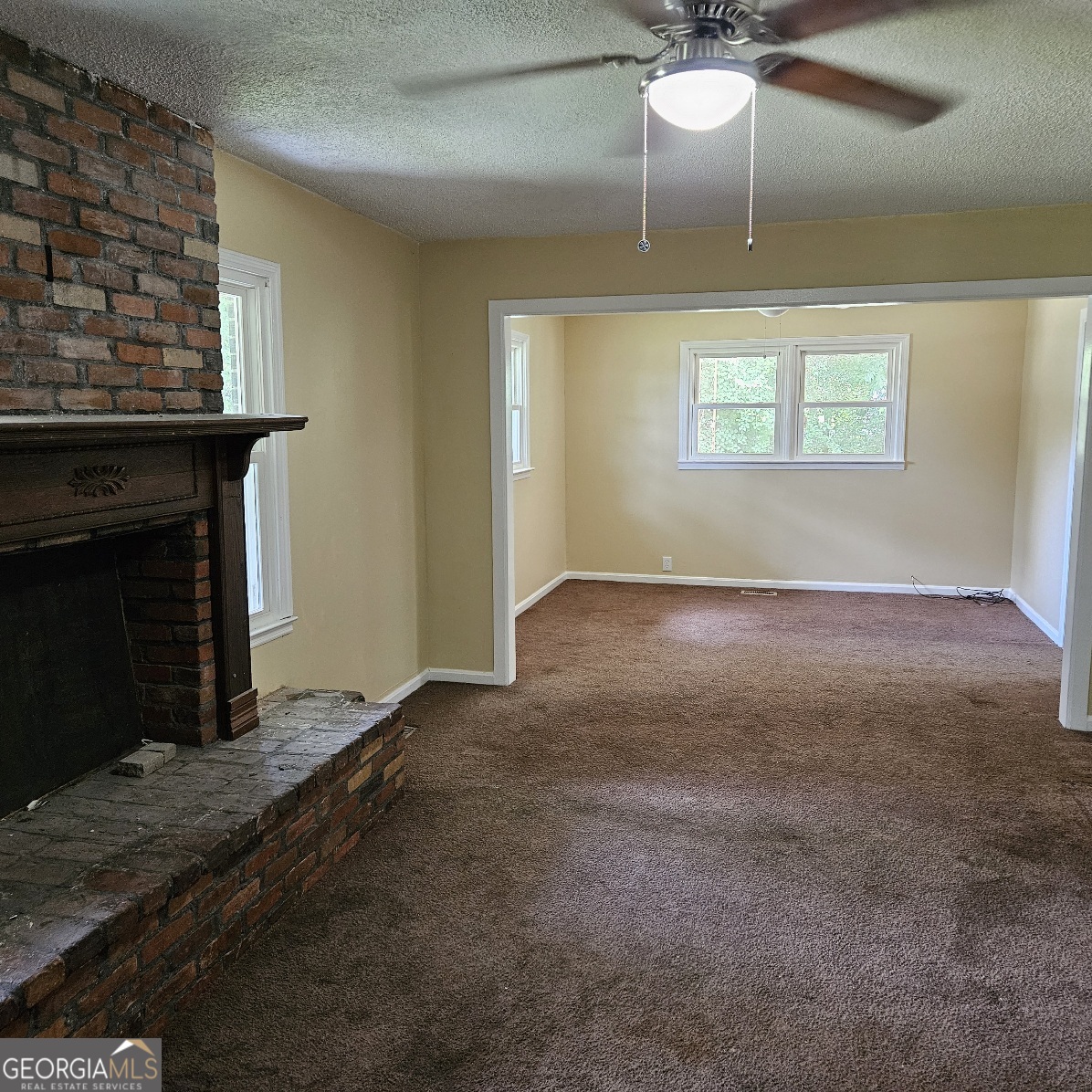 7067 Moseley Road Fort Valley, GA 31030 - Photo 29 of 37 an empty room with windows and fireplace