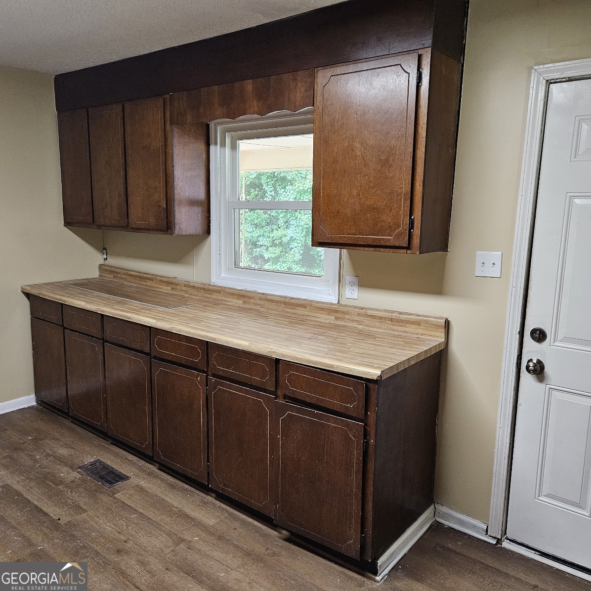 7067 Moseley Road Fort Valley, GA 31030 - Photo 3 of 37 a kitchen with a wooden cabinets and a sink