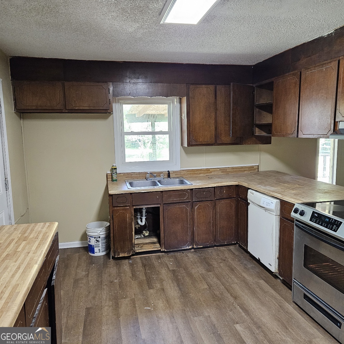 7067 Moseley Road Fort Valley, GA 31030 - Photo 35 of 37 a kitchen with a sink and a stove top oven
