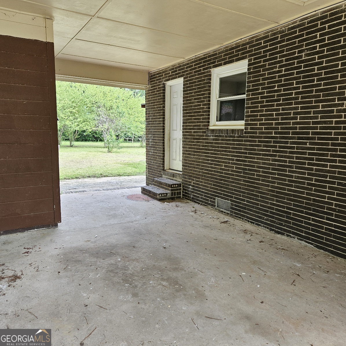 7067 Moseley Road Fort Valley, GA 31030 - Photo 5 of 37 a view of a house with a yard and floor to ceiling window