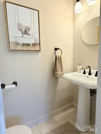 a bathroom with a sink and mirror with toilet