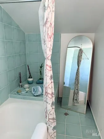 a bedroom with a bed next to a window