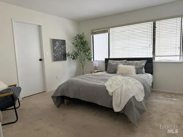 a bedroom with a bed lamp and a fireplace