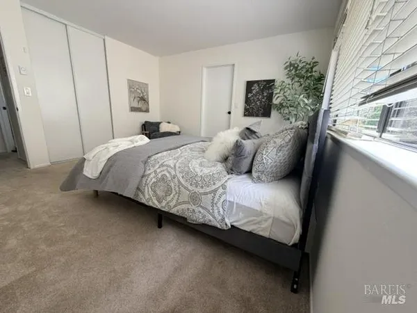 a bedroom with a bed and a window