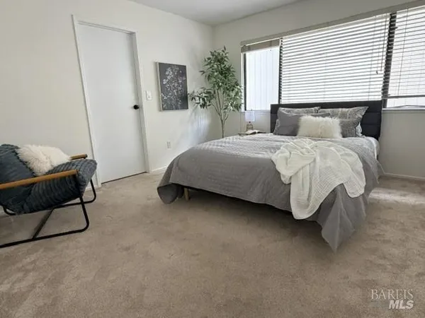 a bedroom with a bed and a mirror