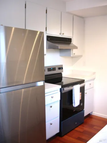 a stove top oven sitting inside of a kitchen