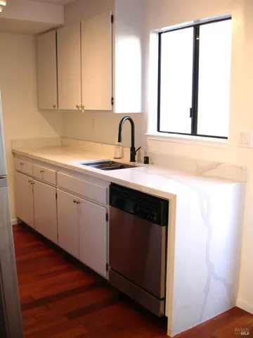 a view of a kitchen with sink and window