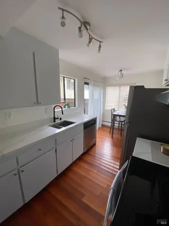a large white kitchen with a large window