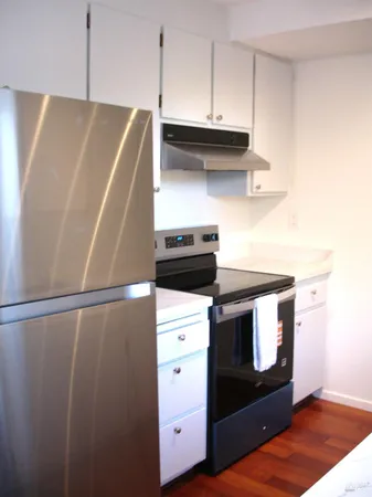 a stove top oven sitting inside of a kitchen