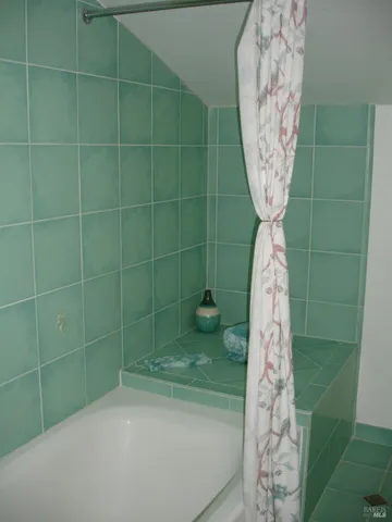 a bathroom with a shower curtain and a sink