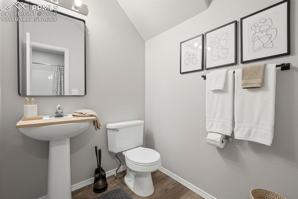 3214 Apogee View Colorado Springs, CO 80906 - Photo 13 of 33 a bathroom with a toilet sink and mirror