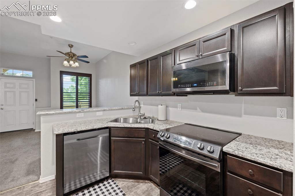 3214 Apogee View Colorado Springs, CO 80906 - Photo 25 of 33 a kitchen with a stove and a sink