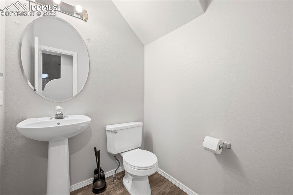 3214 Apogee View Colorado Springs, CO 80906 - Photo 26 of 33 a bathroom with a toilet sink and mirror