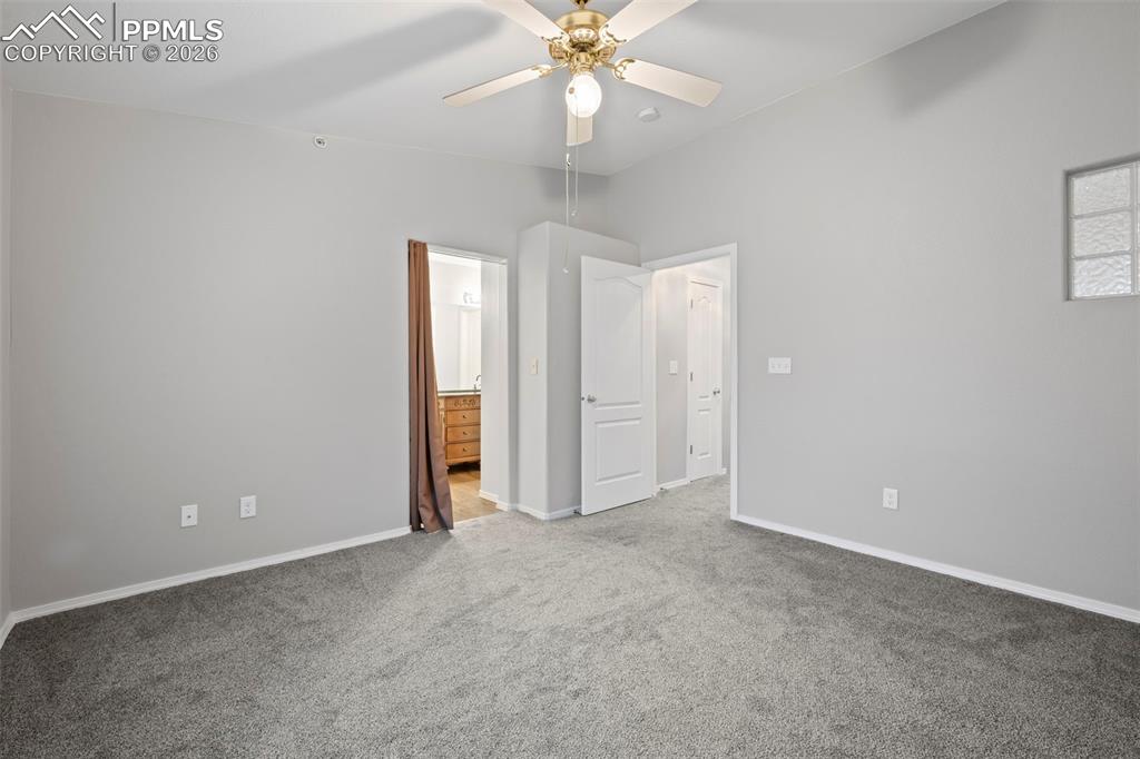 3214 Apogee View Colorado Springs, CO 80906 - Photo 31 of 33 an empty room with chandelier fan and windows