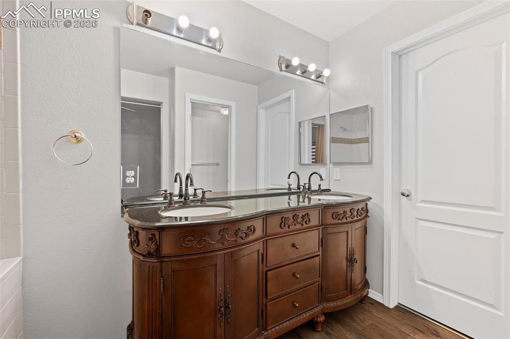 3214 Apogee View Colorado Springs, CO 80906 - Photo 32 of 33 a bathroom with a double vanity sink and mirror