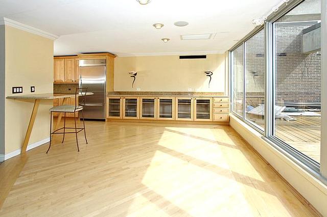 21 West Goethe Street, Unit 19C Chicago, IL 60610 - Photo 4 of 14 a view of a large room with wooden floor and windows