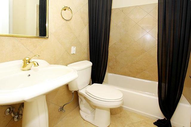 21 West Goethe Street, Unit 19C Chicago, IL 60610 - Photo 9 of 14 a white toilet sitting next to a bathroom sink