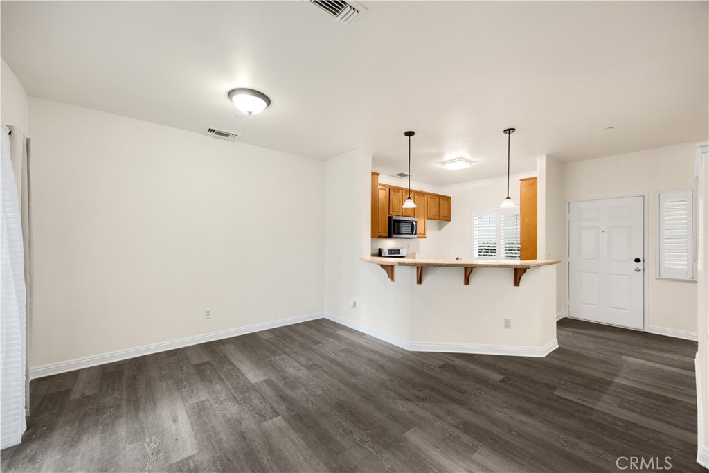 93 Kansas Street, Unit 705 Redlands, CA 92373 - Photo 17 of 33 a view of kitchen with wooden floor and electronic appliances