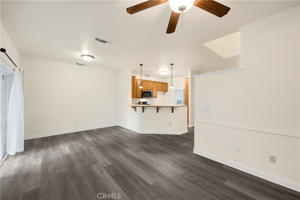 93 Kansas Street, Unit 705 Redlands, CA 92373 - Photo 18 of 33 wooden floor in an empty room with a window