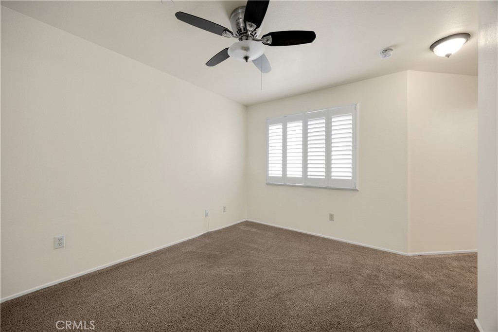 93 Kansas Street, Unit 705 Redlands, CA 92373 - Photo 27 of 33 en empty room with windows and ceiling fan