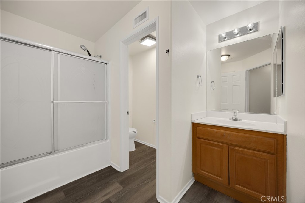 93 Kansas Street, Unit 705 Redlands, CA 92373 - Photo 29 of 33 a bathroom with a shower sink and mirror