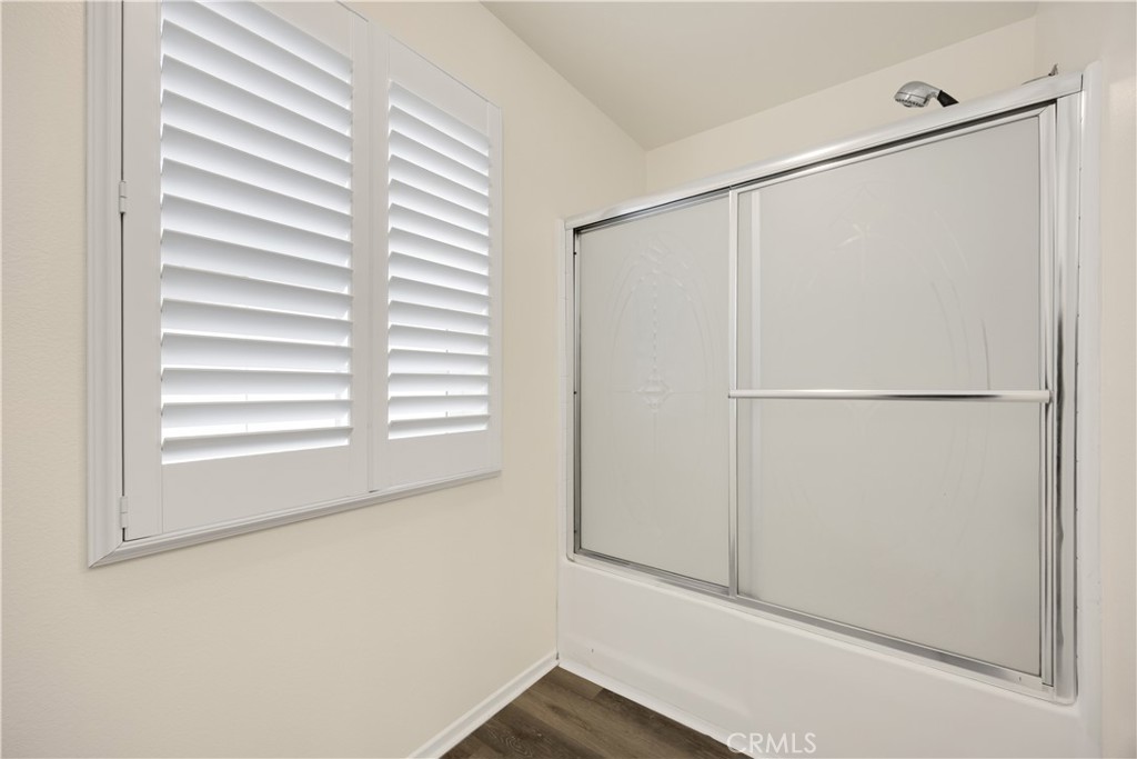 93 Kansas Street, Unit 705 Redlands, CA 92373 - Photo 30 of 33 a view of a small space with wooden floor and a window