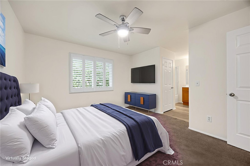 93 Kansas Street, Unit 705 Redlands, CA 92373 - Photo 6 of 33 a bedroom with a bed and a flat screen tv