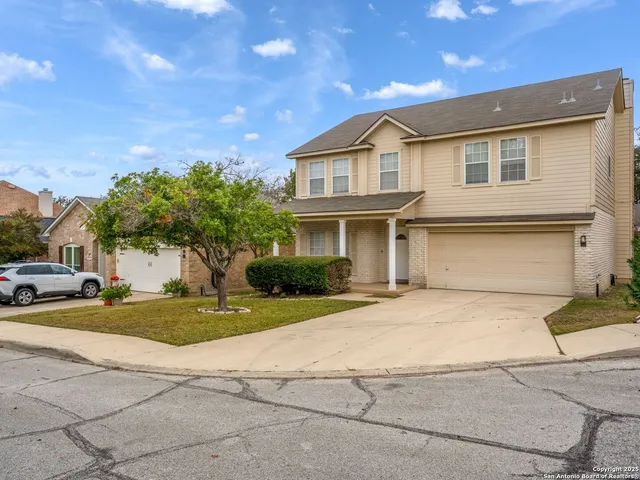 a view of a white house with a yard and plants