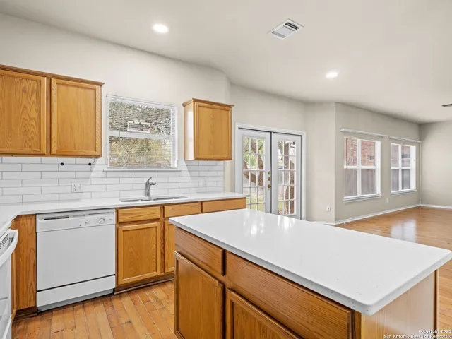 a kitchen with a sink cabinets and window