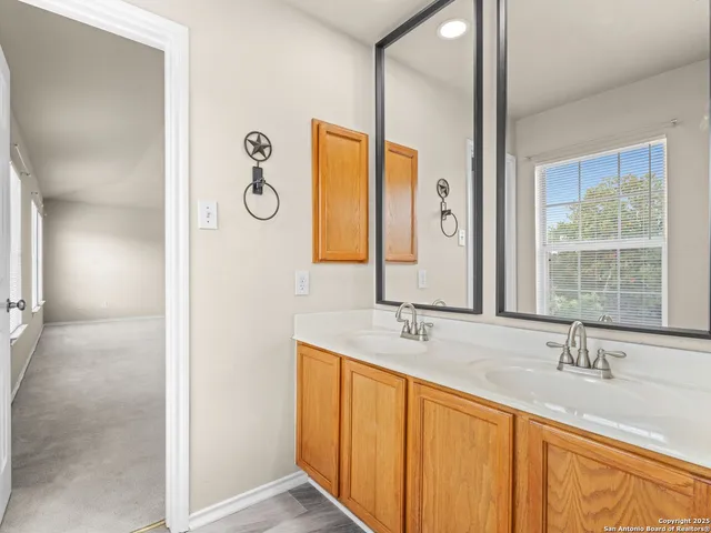 a bathroom with a double vanity sink and a mirror
