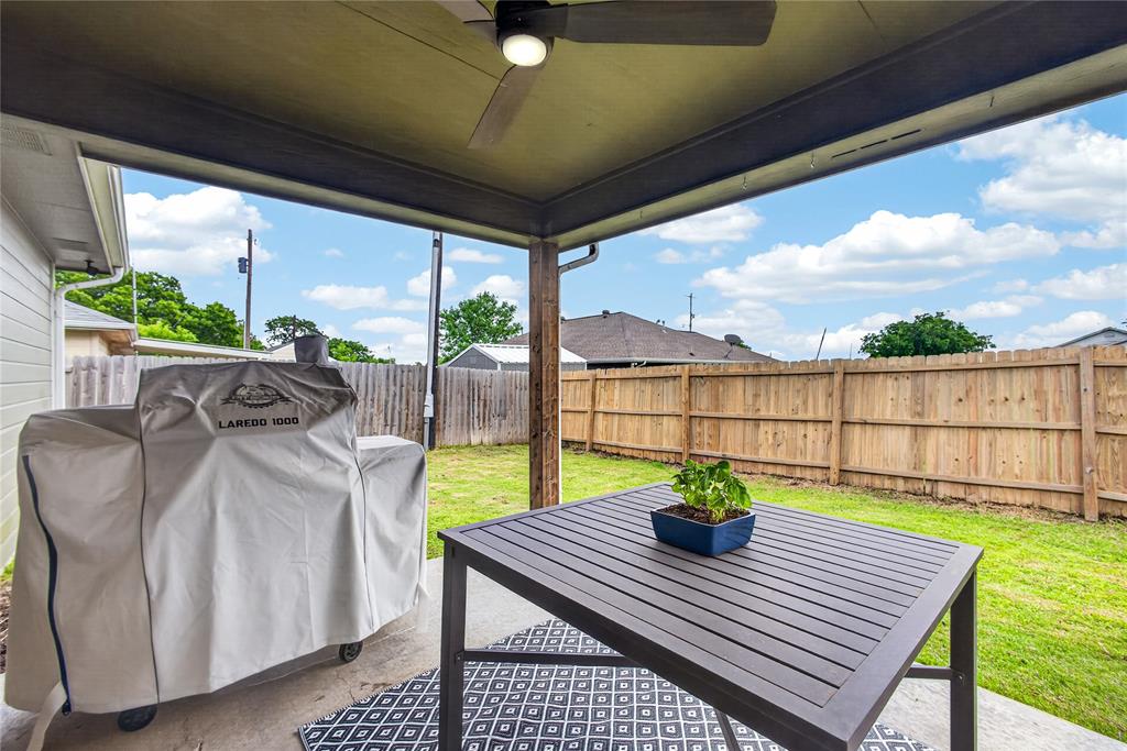 703 College Street Celeste, TX 75423 - Photo 26 of 29 a view of a patio with table and chairs potted plants with wooden floor