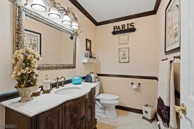 a bathroom with a sink mirror vanity and toilet