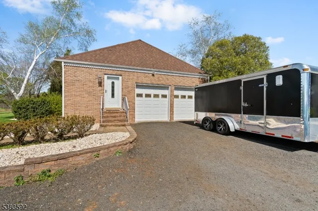a view of a house with a yard and garage