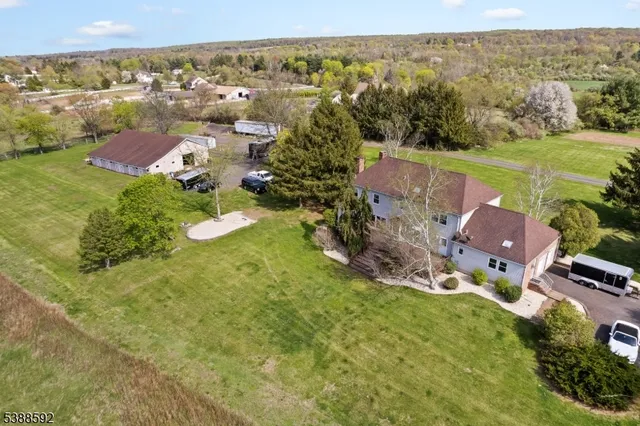 an aerial view of residential houses with outdoor space and ocean view