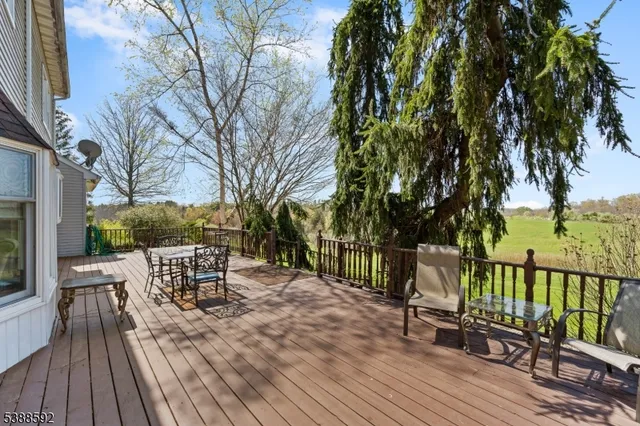 a view of a chairs and table on the wooden deck