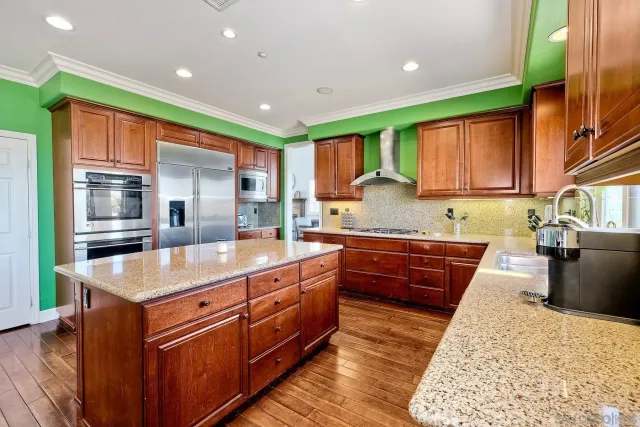 a spacious bedroom with a bed a table and a chair