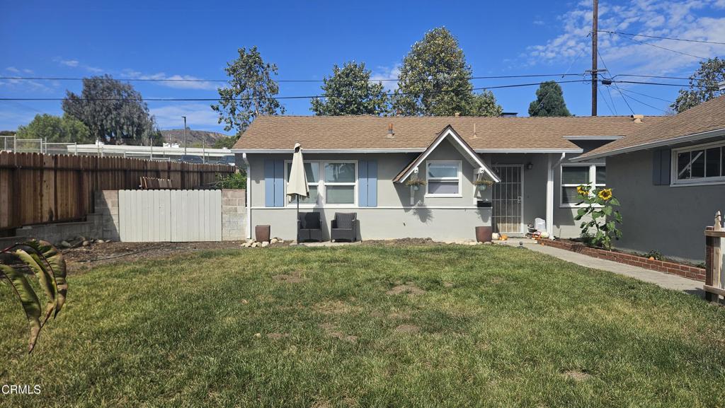 a view of backyard of house with green space