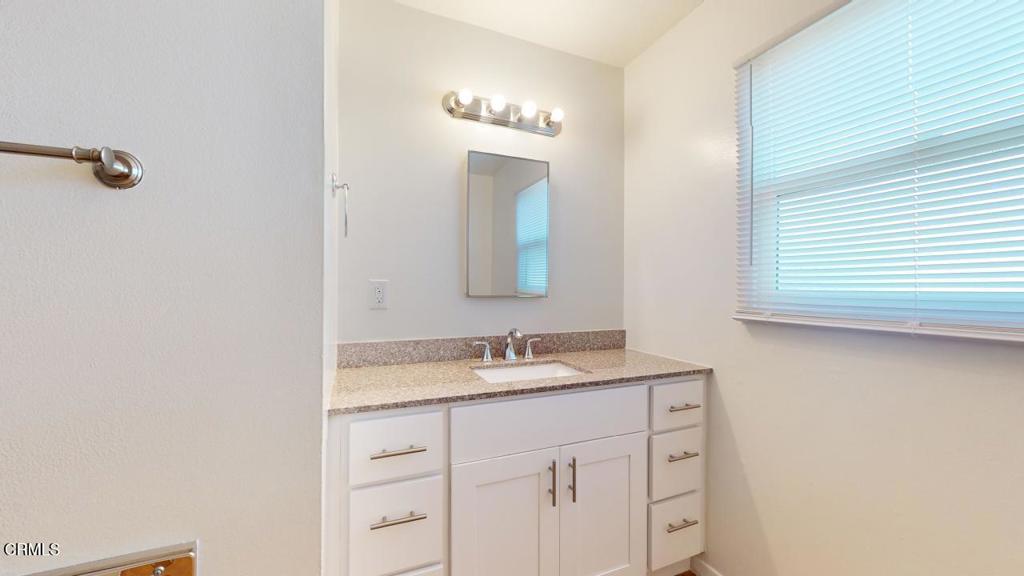 6005 Sutter Street Ventura, CA 93003 - Photo 7 of 11 a bathroom with a sink and a mirror